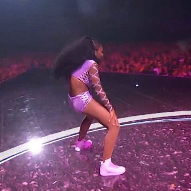 a woman in short shorts and high heels on stage