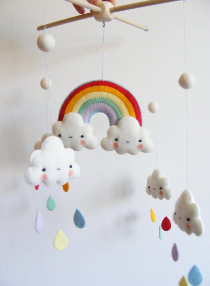 a mobile with clouds, rainbows and rain drops hanging from it's sides