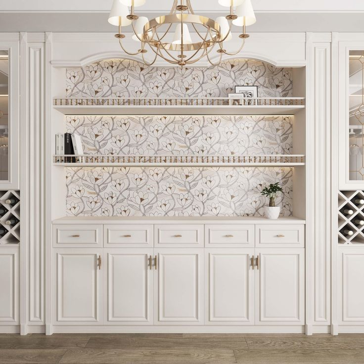 a room with white cabinets and a chandelier