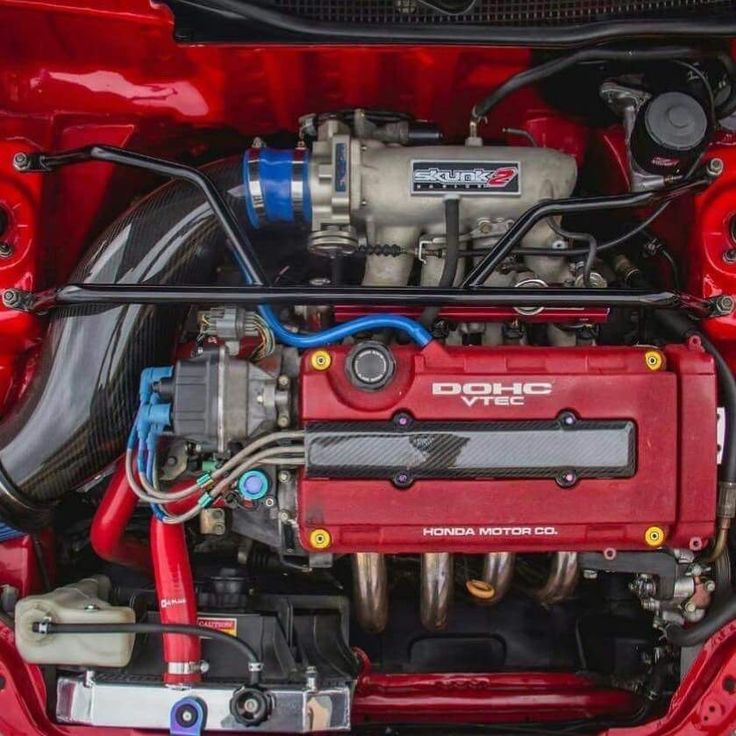 the engine compartment of a red sports car