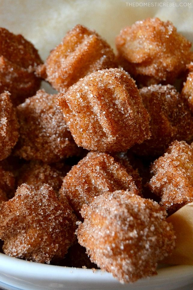 sugared donuts in a white bowl on a table