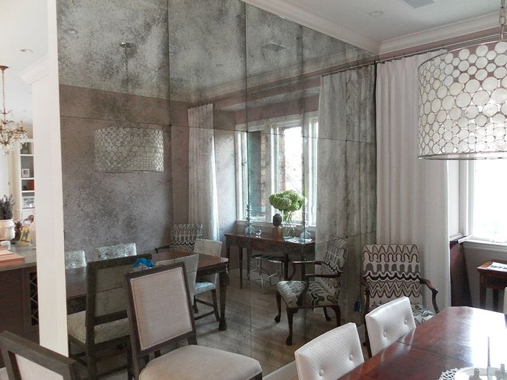 a dining room table with chairs and a chandelier hanging from it's ceiling