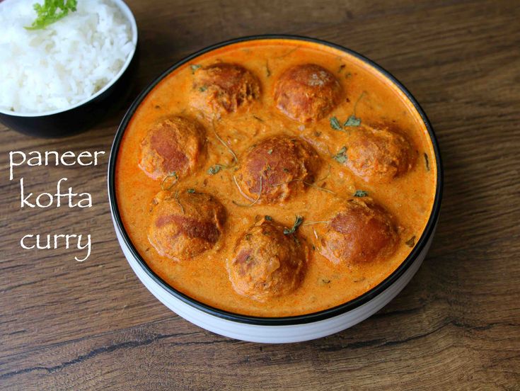 a paneer kofta curry with meatballs in a bowl next to rice