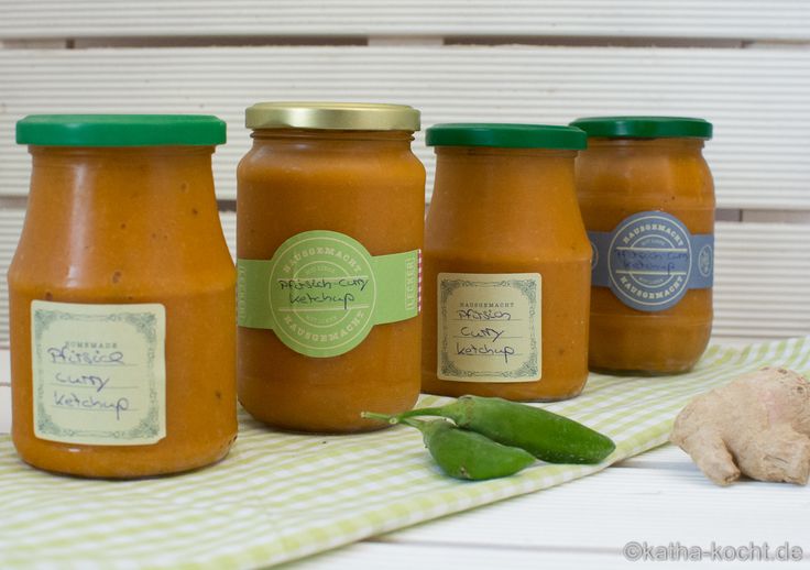 four jars of sauce sitting on top of a table