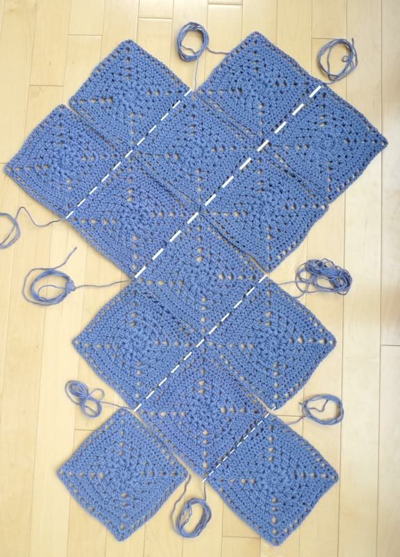 four crocheted squares are laid out on the floor to be knitted together