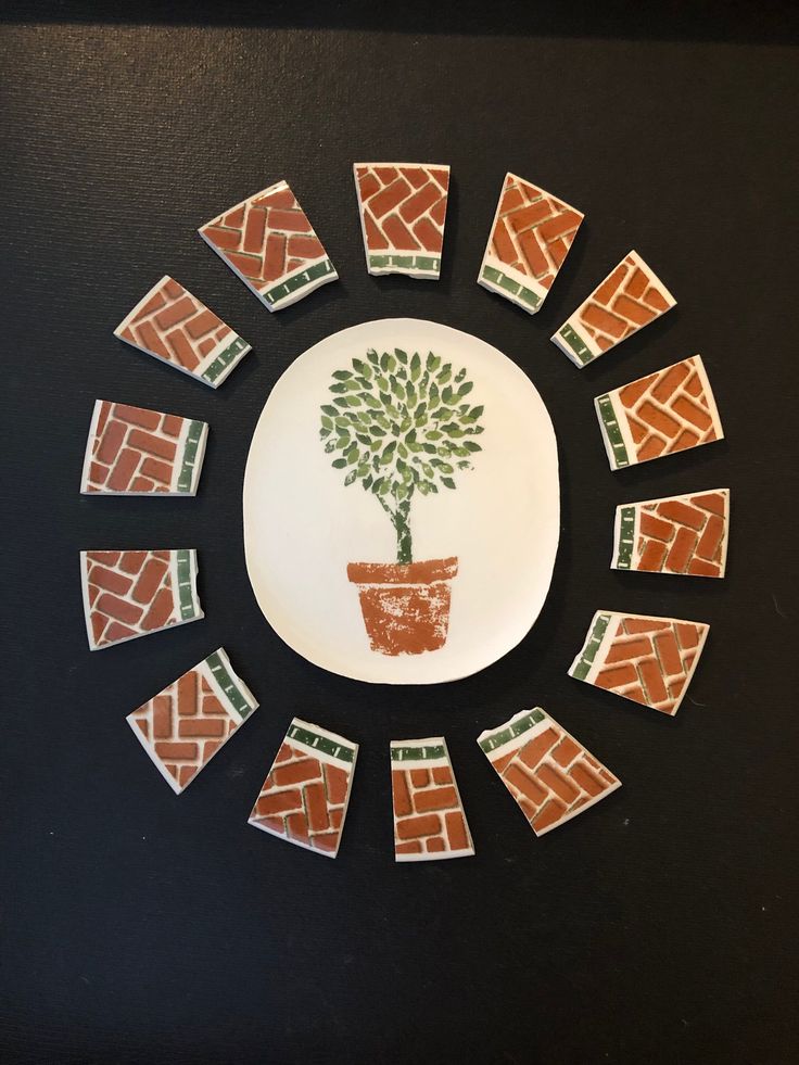 a plate that has a tree on it in the middle of some squares around it