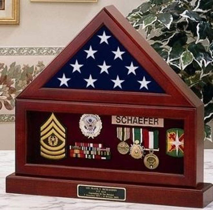 a display case with medals and other items in the shape of an american flag on it