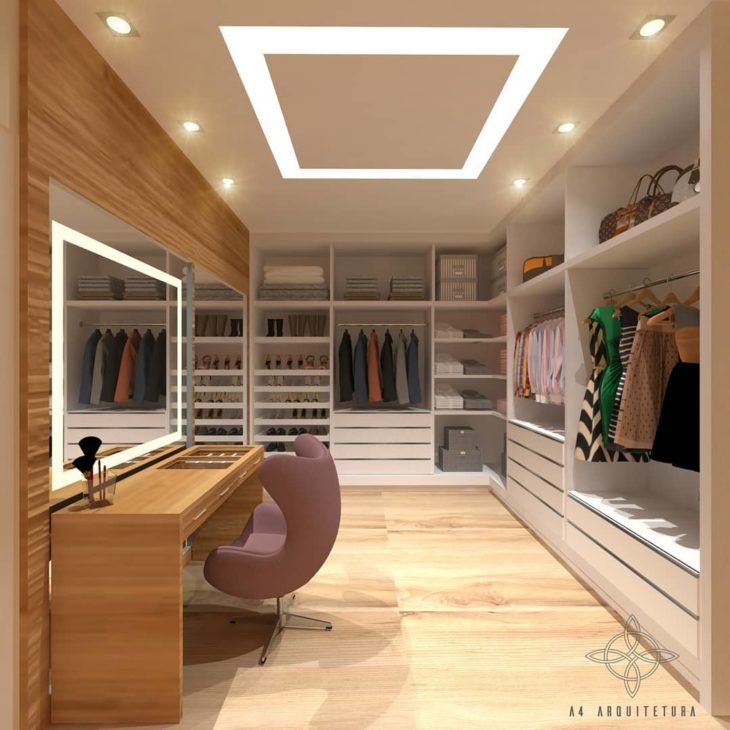 an empty walk - in closet with clothes on shelves