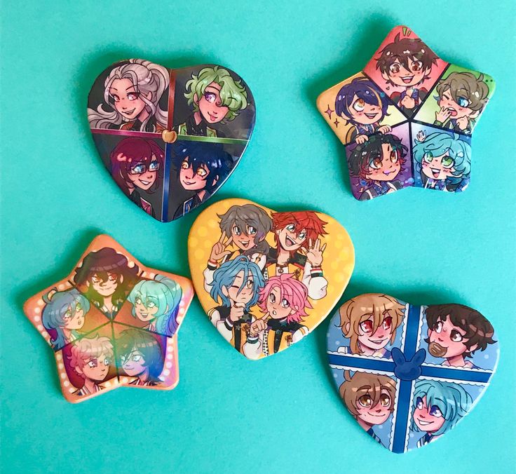 four heart shaped cookies decorated with anime characters on blue background, one has a cross and the other has an umbrella