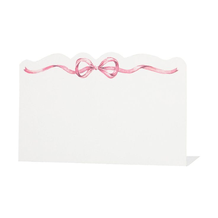 a white card with pink ribbon on it