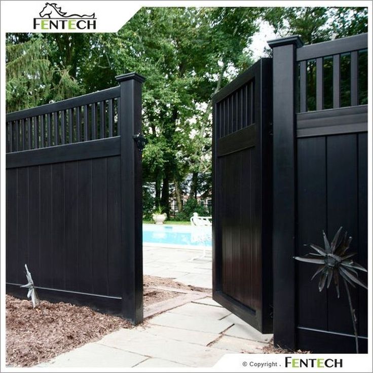 two black gates are open in front of a pool