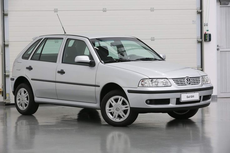 a silver car parked in front of a garage door