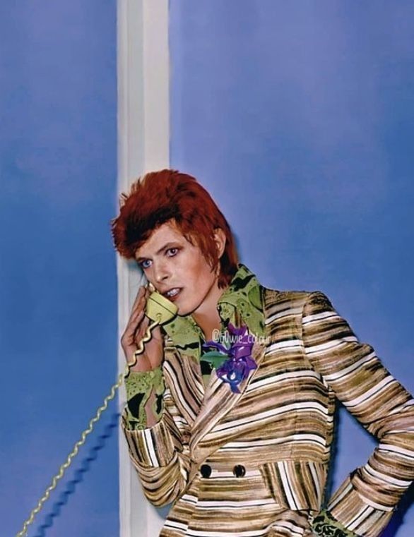 a woman with red hair is talking on the phone