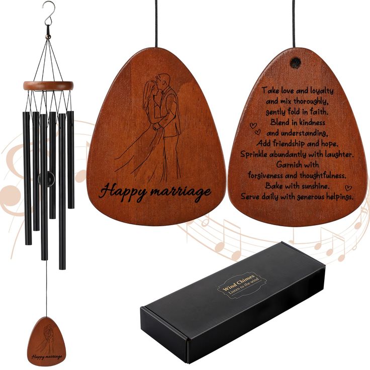 a wooden wind chime with an engraved message on it and a box next to it