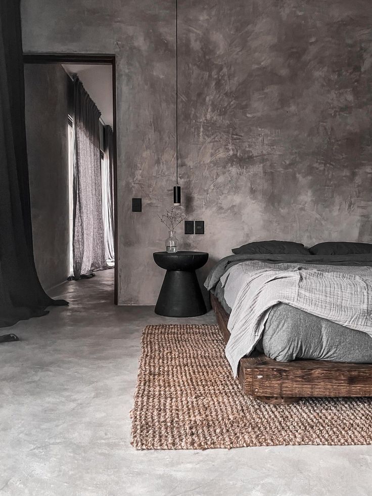 a bed sitting on top of a rug next to a window