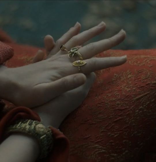 two hands holding each other with rings on them