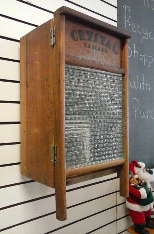 a chalkboard mounted to the side of a wall next to a stuffed santa clause