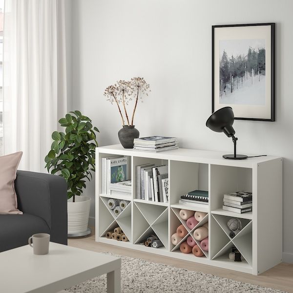 a living room with a couch, coffee table and bookshelf