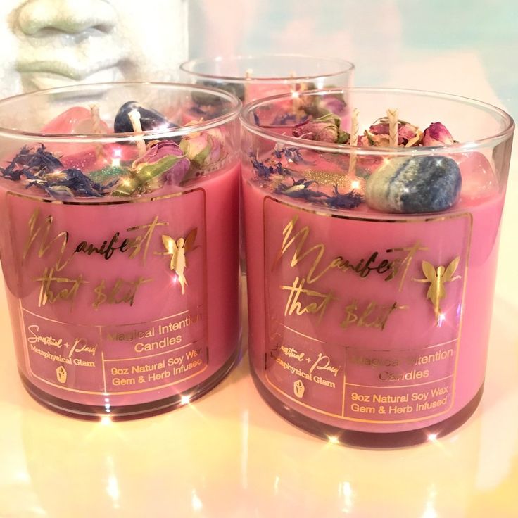 two pink candles sitting next to each other on a table