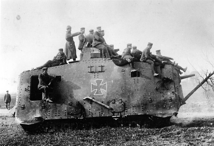 an old tank with men sitting on top of it