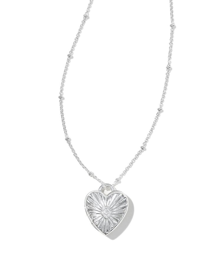 Keep your loved one close to your heart with the Meredith Sterling Silver Locket Necklace in White Topaz. Crafted with long-lasting metal and embellished with white topaz detailing, this sweet locket style is so easy to love. Subtle yet oh-so-darling, it’s one you’ll wear over and over. Metal Sterling Silver Why Sterling Silver? Our Sterling Silver collection features elevated styles to wear time and time again. With a base of both pure silver and copper, Sterling Silver provides a precious yet affordable option that offers long-lasting wear and shine and is the perfect addition to your Demi-Fine jewelry rotation. Learn More About Metals & Care Material White Topaz Closure Lobster Clasp Size 18" L Chain With A 0.71" L X 0.62" W Pendant With A 2" ExtenderDue to the one-of-a-kind nature of t Kendra Scott Butterfly Necklace Silver, Silver Necklace Locket, Simple Silver Pendant, Silver Jewelry Aesthetic Earrings, Lockets Silver, Jewelry Inspo Silver, Small Silver Necklace, Silver Necklace Heart, Locket Necklace Silver