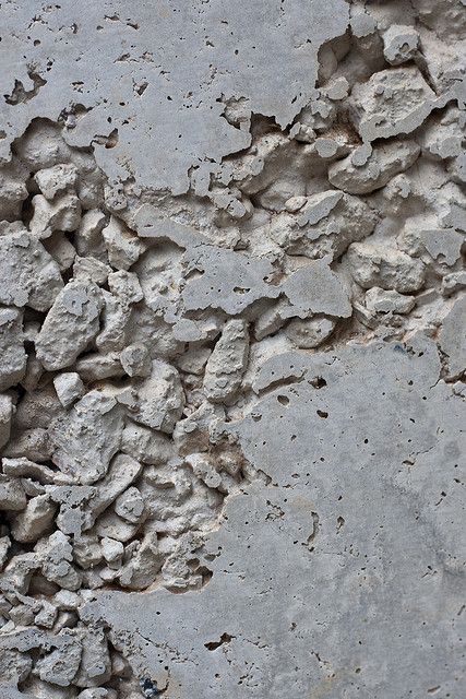 a cement wall that has some rocks on it