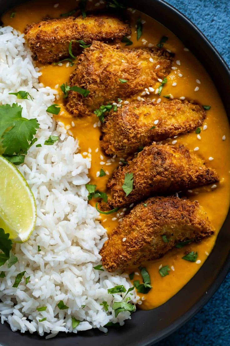 a plate with rice, chicken and cilantro sauce