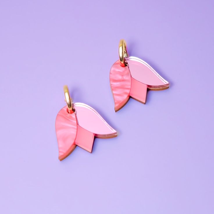 These Tulip charms add a lovely monochrome pop of color and are small and cute enough for when you want to be a little subtle. Hand-crafted from a combo of marbled, mirrored and frosted acrylic, paired with hand-stained wood. They hang from elegant 15mm gold-filled hoops and are removable so you can wear the hoops on their own—two earrings in one, perfect for travel! Hand-crafted in New York City. Gold-filled hoops are perfect for sensitive ears! Due to the hand-made nature of these pieces, your Diy Resin Earrings, Laser Engraved Earrings, Tulip Earrings, Two Earrings, Blue Charm, Hoop Charms, Frosted Acrylic, Purple Tulips, Gold Filled Hoops