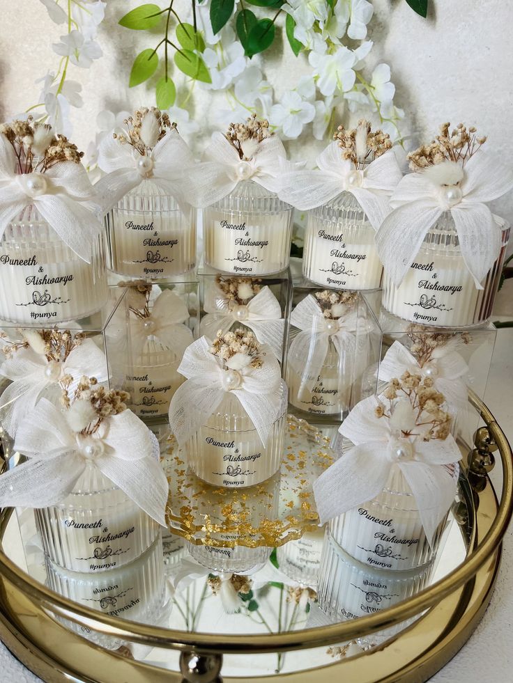 a bunch of bottles that are sitting on a tray with some flowers in the background