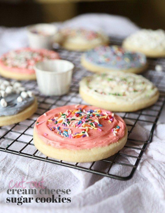 cookies with frosting and sprinkles on a cooling rack