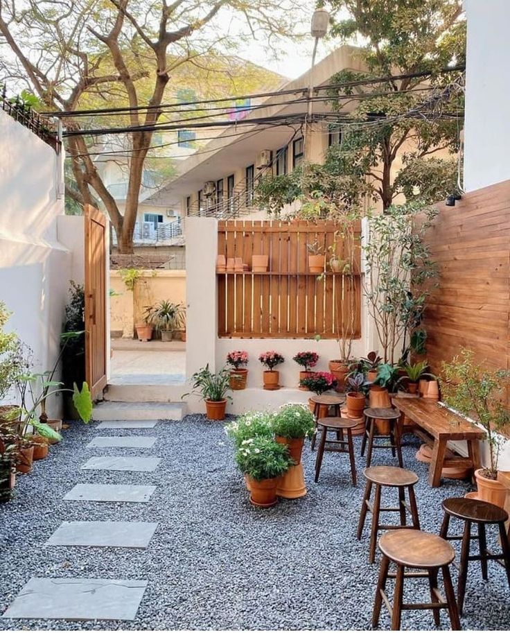 an outdoor patio with wooden tables and chairs