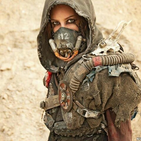 a woman wearing a gas mask in the desert