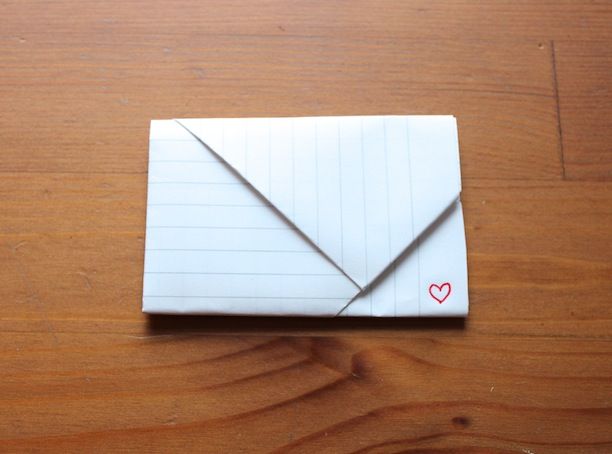 an origami envelope with a heart drawn on it