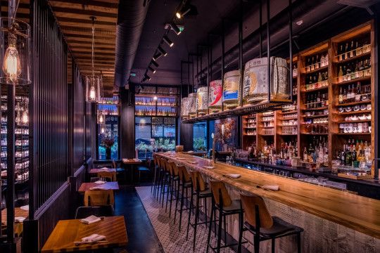 an empty bar with lots of bottles on the shelves