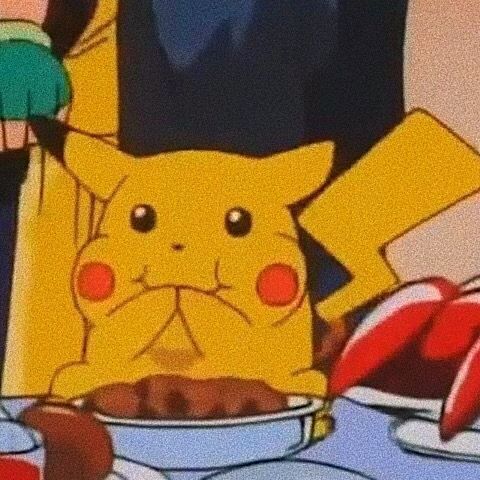 the pikachu is sitting in front of some food