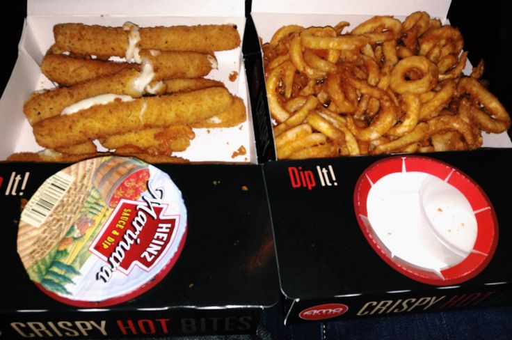 two boxes filled with onion rings and dip