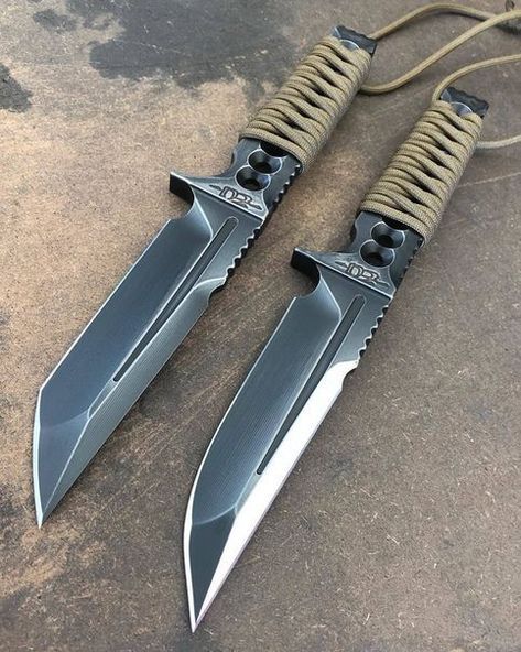 two knives are laying next to each other on the ground