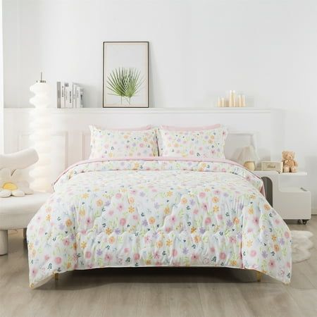 a bedroom with white walls and flooring has a floral comforter set on the bed