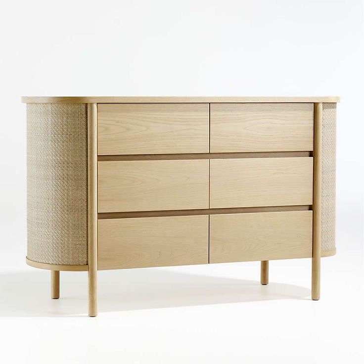 a wooden dresser with several drawers and two baskets on it's sides, against a white background