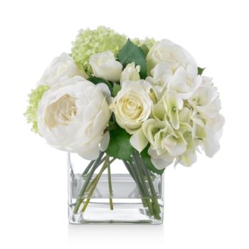 a vase filled with white and green flowers