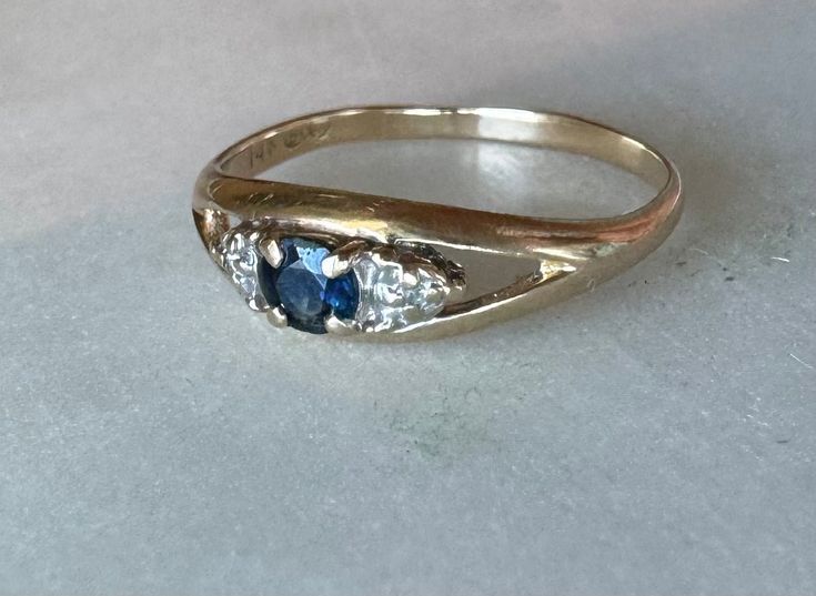 14k Vintage Sapphire & Diamond Ring Description: This 14k vintage ring features a stunning blue sapphire center stone accented by natural diamonds on either side. Currently sized at 5 3/4, it is resizable upon request. This dainty ring is perfect for stacking and adds a touch of elegance to any jewelry collection. Weighing 1.46 grams, it's a lightweight yet durable piece that can be worn daily or on special occasions. This piece, like all our jewelry, is a rare find--once it's gone, it's gon Zierlicher Ring, Vintage Sapphire, Sapphire Diamond Ring, Antique Engagement Rings, Dainty Ring, Vintage Ring, Engagement Rings Sapphire, Sapphire Diamond, Vintage Rings