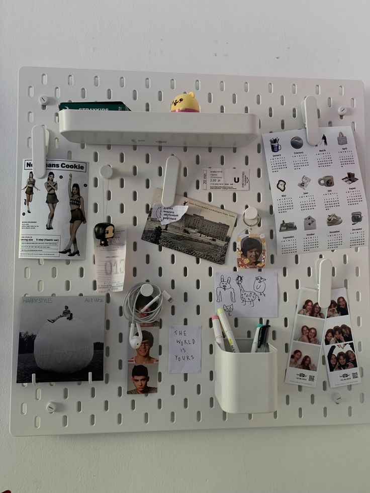 a white pegboard with pictures and other items on it