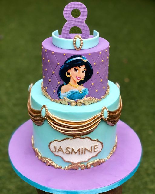 a purple and blue cake with a princess on top