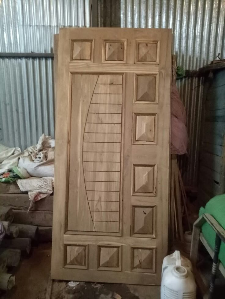 a large wooden door sitting inside of a building