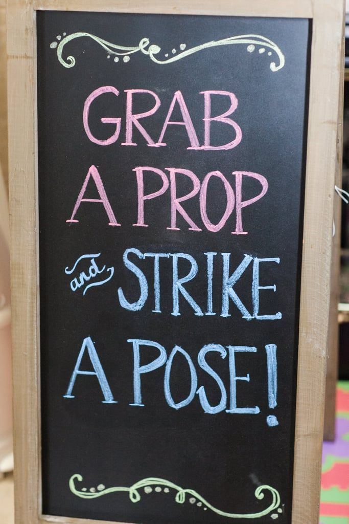 a chalkboard sign that says grab a prop and strike a pose