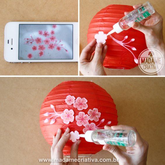 the paper lantern is being used to make a cherry blossom decoration with glue on it