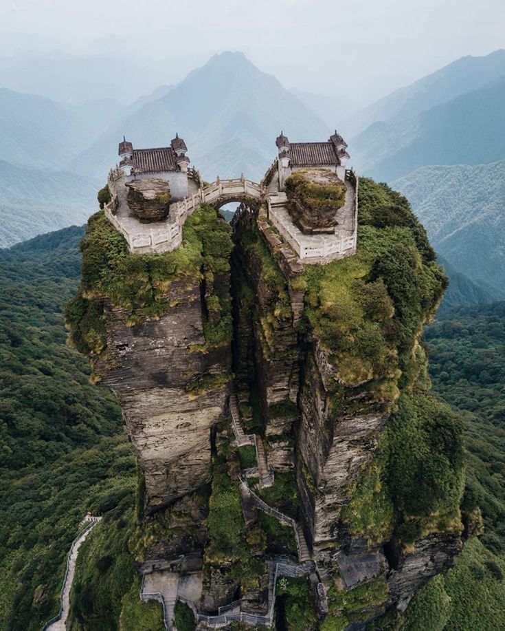 an aerial view of a castle on top of a mountain in the middle of nowhere