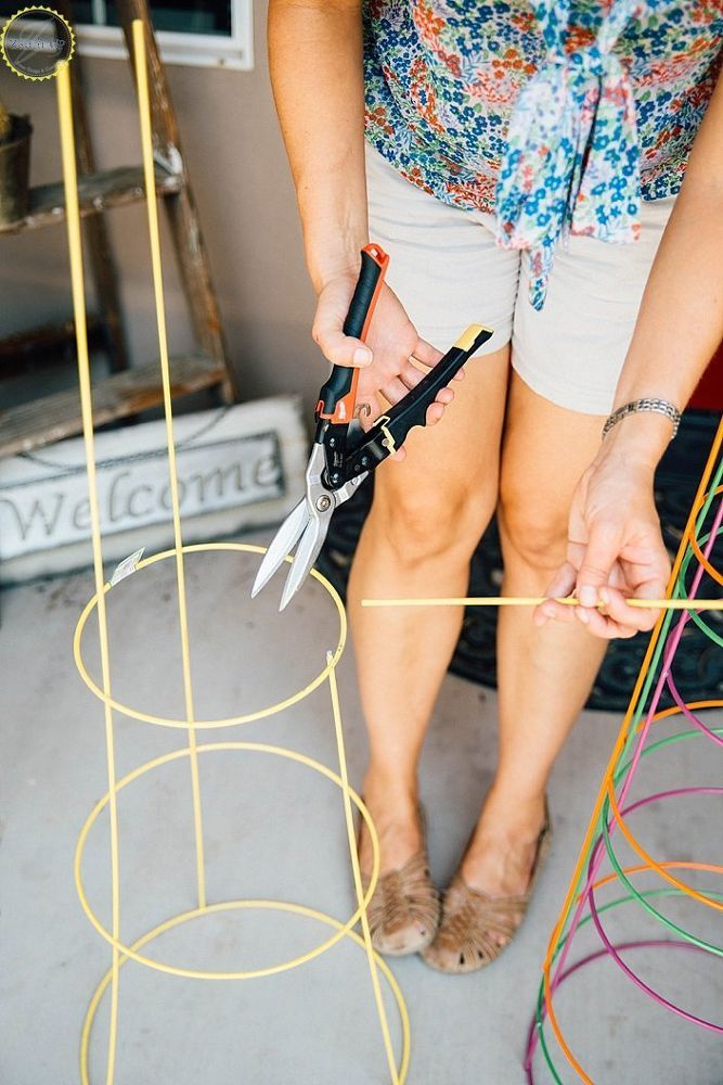 a woman standing next to a bunch of scissors