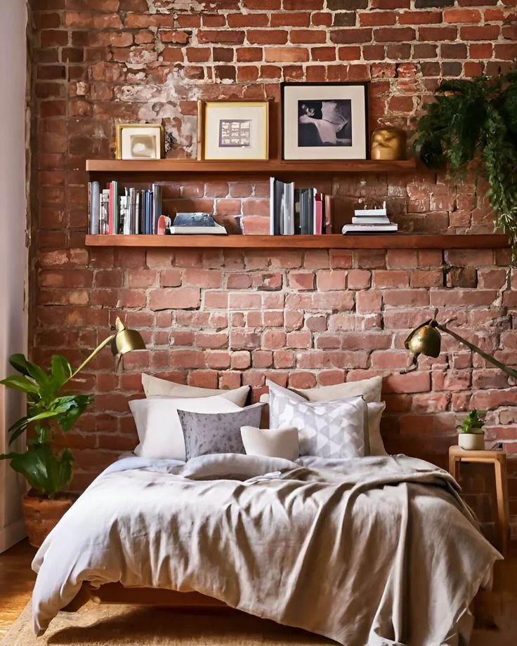 a bedroom with brick walls and shelves above the bed, as well as a potted plant