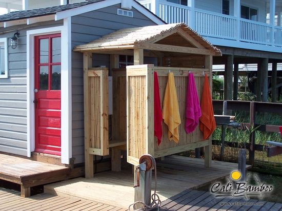 a small wooden shed with towels hanging outside